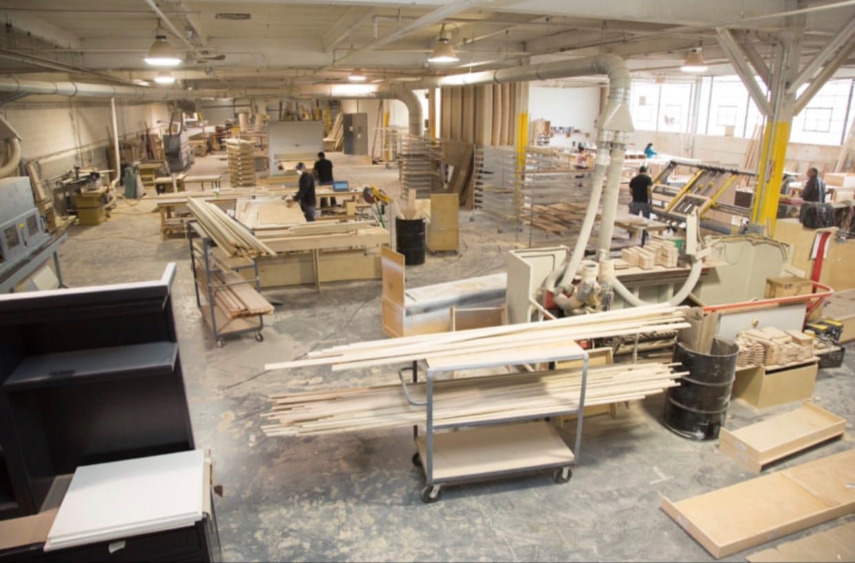Luxury custom cabinetry manufacturing facility at Cambridge Kitchens in Hicksville, New York, showcasing advanced machinery, in-house production, and precision craftsmanship behind fully custom luxury kitchens.