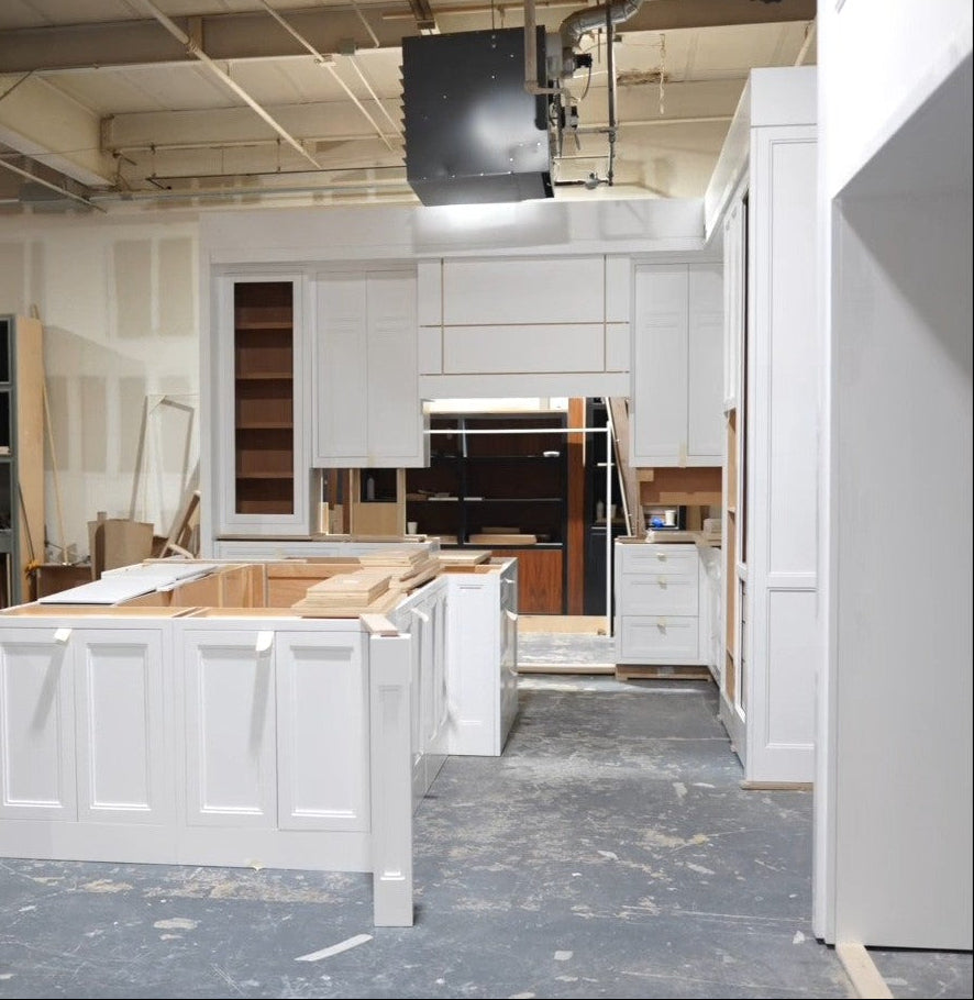 Fully assembled luxury custom kitchen inside the Cambridge Kitchens manufacturing facility in Hicksville, New York, prepared for the client's factory review before delivery and installation.