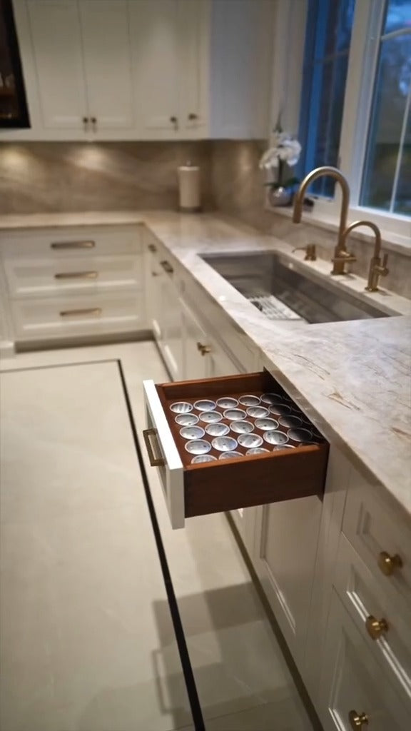 Custom walnut drawer organization designed for a luxury kitchen by Cambridge Kitchens.