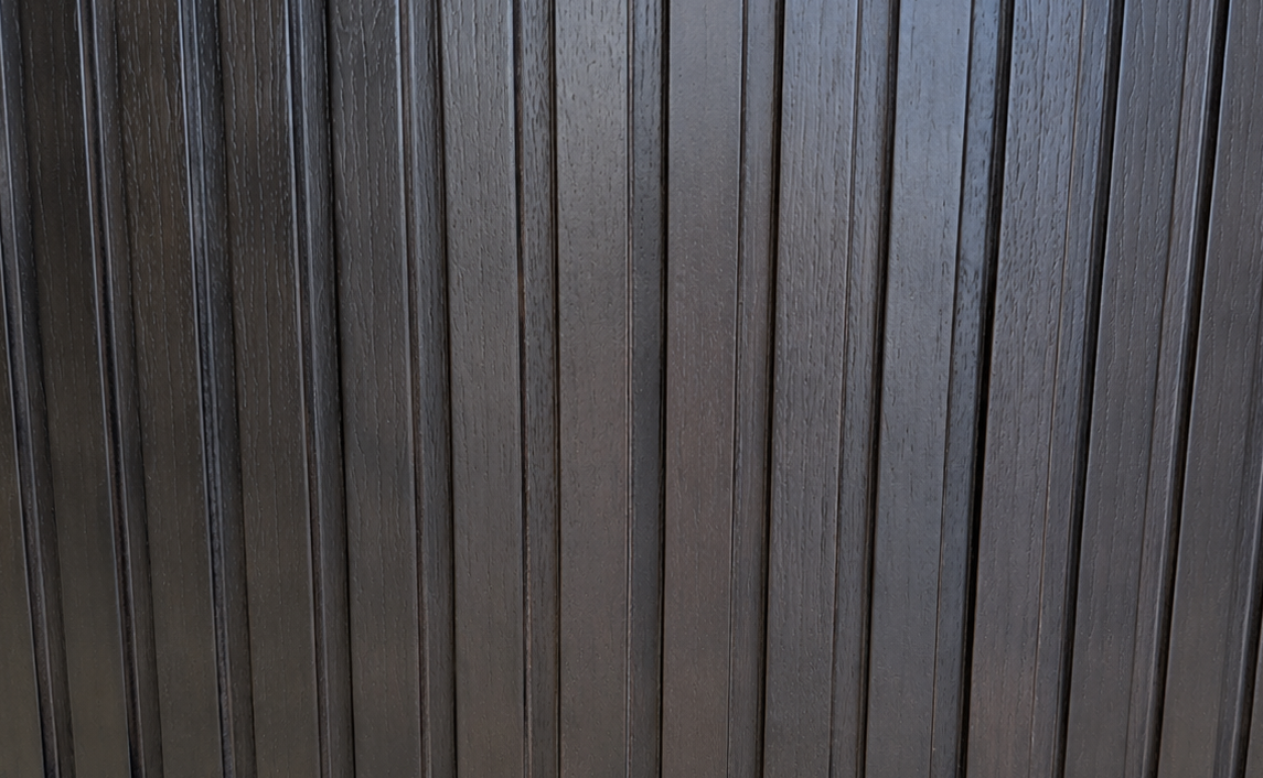 Close-up of the precision-machined 1/2-inch walnut fluting on the Cambridge Kitchens Fluted Round Coffee Table.