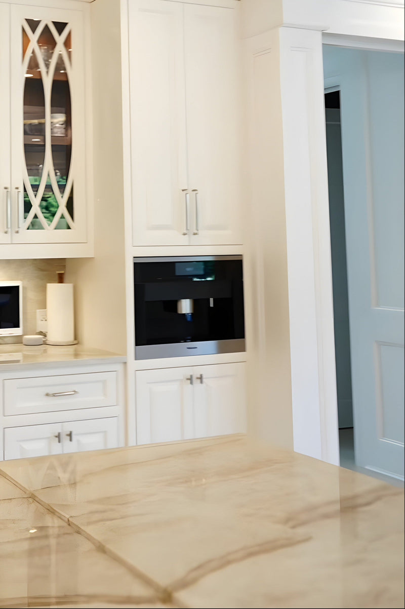 Luxury built-in coffee station with custom wood cabinetry, integrated Miele coffee maker, glass display cabinets, and brass hardware.