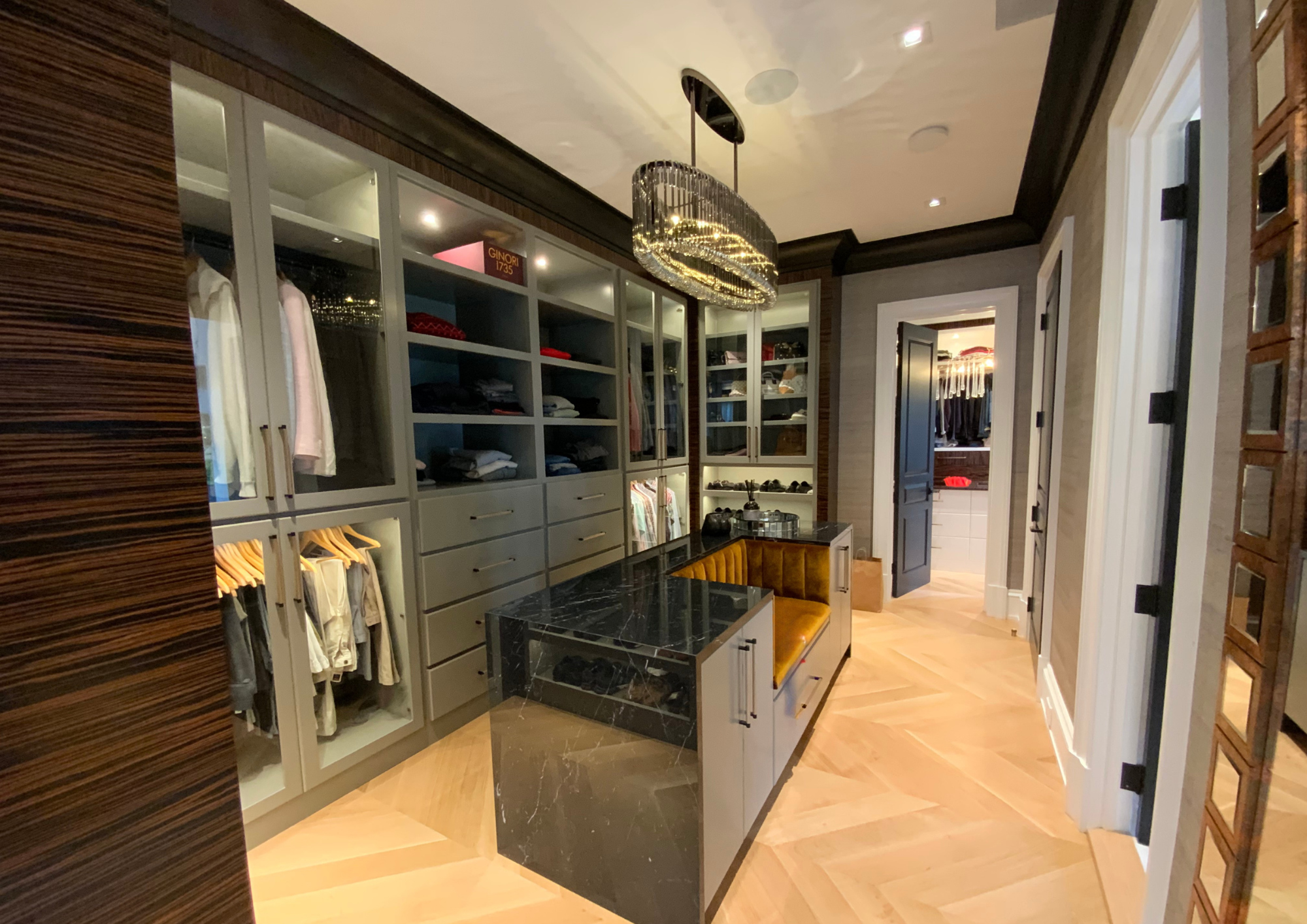 Luxury custom walk-in closet with integrated lighting and custom cabinetry by Cambridge Kitchens.