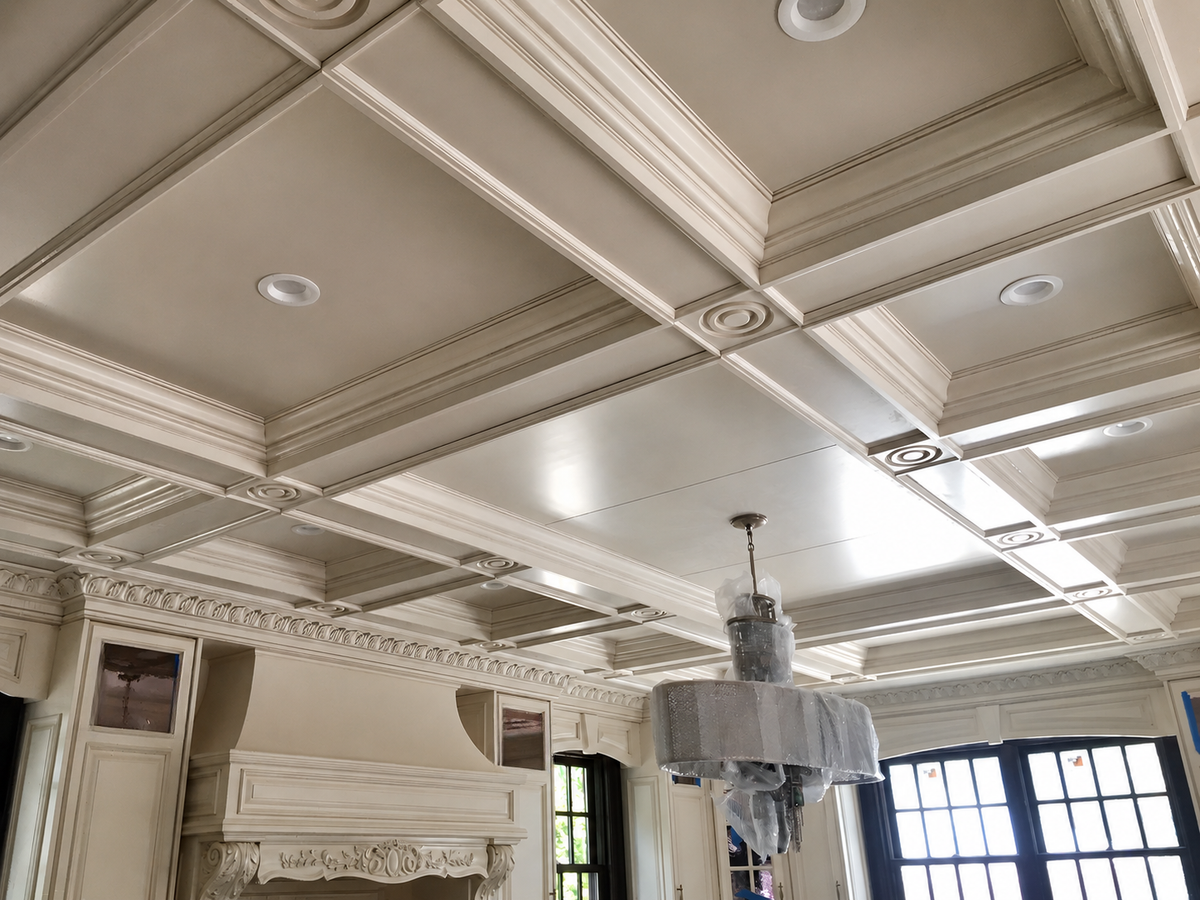 Ornate custom coffered ceiling with layered molding, decorative rosettes and detailed architectural millwork by Cambridge Kitchens on Long Island.